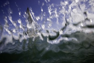 Above and below the water surface as a yacht rounds the windward mark on Day 5 of the Rolex Commodores Cup 2008 in the Solent, UK.