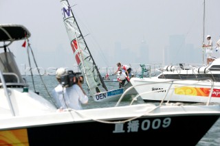 Qingdao, China, 20080809: 2008 OLYMPICS - racing in the Olympic Sailing Event. Danish 49er sailors Jonas Warrer and Martin Kirketerp get stuck on the commitee boat in their practice race.   (no sale to Denmark)