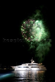 Benetti superyacht moored at anchor at night for social event