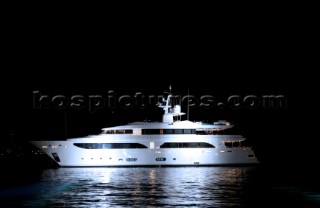 Benetti superyacht moored at anchor at night for social event