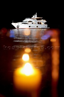 Benetti superyacht moored at anchor at night for social event