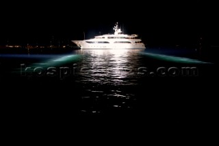 Benetti superyacht moored at anchor at night for social event