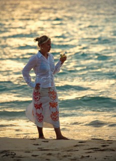 Girl relaxing on beach whilst cruising Malaysia on the tradional yacht Silolona