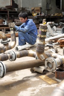 Yacht builders and skilled workers boatbuilding at the Cheoy Lee shipyard and boatbuilders in China