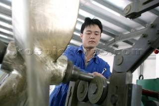 Yacht builders and skilled workers boatbuilding at the Cheoy Lee shipyard and boatbuilders in China. Manufacturing propellers.