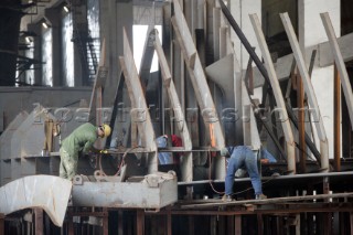 Yacht builders and skilled workers boatbuilding at the Cheoy Lee shipyard and boatbuilders in China. Welders welding.