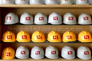 Yacht builders and skilled workers boatbuilding at the Cheoy Lee shipyard and boatbuilders in China. Helmets.