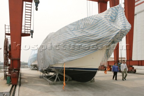 Yacht builders and skilled workers boatbuilding at the Double Happiness shipyard and boatbuilders in