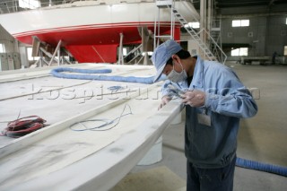 Yacht builders and skilled workers boatbuilding at the Double Happiness shipyard and boatbuilders in China