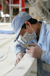 Yacht builders and skilled workers boatbuilding at the Double Happiness shipyard and boatbuilders in China