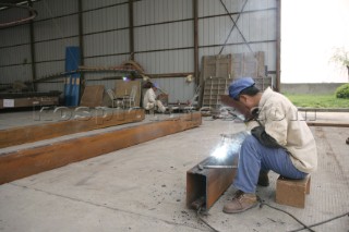 Yacht builders and skilled workers boatbuilding at the Double Happiness shipyard and boatbuilders in China