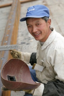 Yacht builders and skilled workers boatbuilding at the Double Happiness shipyard and boatbuilders in China