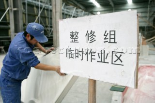 Yacht builders and skilled workers boatbuilding at the Double Happiness shipyard and boatbuilders in China