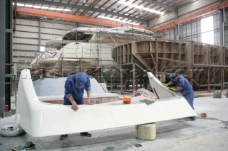 Yacht builders and skilled workers boatbuilding at the Double Happiness shipyard and boatbuilders in China