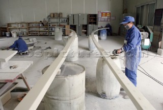 Yacht builders and skilled workers boatbuilding at the Double Happiness shipyard and boatbuilders in China