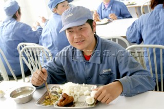 Yacht builders and skilled workers boatbuilding at the Double Happiness shipyard and boatbuilders in China