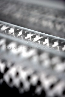 Yacht builders and skilled workers boatbuilding at the Hansheng shipyard and boatbuilders in China. Detail of carbon tubes and poles.