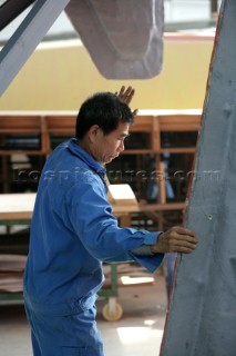 Yacht builders and skilled workers boatbuilding at the Hansheng shipyard and boatbuilders in China