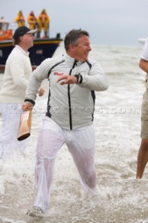 THE SOLENT, UK - August 31st: For a briefÊspellÊonce each summer on the lowest of spring tides, members of the Island Sailing Club and Royal Southern Yacht Club sail outÊto The Brambles sand bank in the middle of The Solent andÊplay cricket, before the tide rushes back in one hour later.ÊThe fixture was first started in the 1950Õs by the late Uffa Fox, a sailing companion of the Duke of Edinburgh, the Royal Southern and the Island Sailing Club compete every year. As soon as the sandbank appears the stumps are put up and the match gets under way. Many of the competitors dress all in cricket whites and ÔThe Bramble InnÕ is erected to serve drinks to spectators. The Bramble Inn is one of the most bizarre pubs in England: it is in the middle of the sea and exists only for about an hour each year.