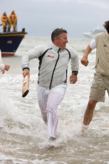 THE SOLENT, UK - August 31st: For a briefÊspellÊonce each summer on the lowest of spring tides, members of the Island Sailing Club and Royal Southern Yacht Club sail outÊto The Brambles sand bank in the middle of The Solent andÊplay cricket, before the tide rushes back in one hour later.ÊThe fixture was first started in the 1950Õs by the late Uffa Fox, a sailing companion of the Duke of Edinburgh, the Royal Southern and the Island Sailing Club compete every year. As soon as the sandbank appears the stumps are put up and the match gets under way. Many of the competitors dress all in cricket whites and ÔThe Bramble InnÕ is erected to serve drinks to spectators. The Bramble Inn is one of the most bizarre pubs in England: it is in the middle of the sea and exists only for about an hour each year.