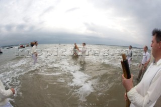 THE SOLENT, UK - August 31st: For a briefÊspellÊonce each summer on the lowest of spring tides, members of the Island Sailing Club and Royal Southern Yacht Club sail outÊto The Brambles sand bank in the middle of The Solent andÊplay cricket, before the tide rushes back in one hour later.ÊThe fixture was first started in the 1950Õs by the late Uffa Fox, a sailing companion of the Duke of Edinburgh, the Royal Southern and the Island Sailing Club compete every year. As soon as the sandbank appears the stumps are put up and the match gets under way. Many of the competitors dress all in cricket whites and ÔThe Bramble InnÕ is erected to serve drinks to spectators. The Bramble Inn is one of the most bizarre pubs in England: it is in the middle of the sea and exists only for about an hour each year.