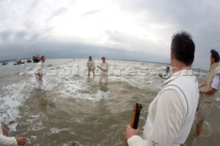 THE SOLENT, UK - August 31st: For a briefÊspellÊonce each summer on the lowest of spring tides, members of the Island Sailing Club and Royal Southern Yacht Club sail outÊto The Brambles sand bank in the middle of The Solent andÊplay cricket, before the tide rushes back in one hour later.ÊThe fixture was first started in the 1950Õs by the late Uffa Fox, a sailing companion of the Duke of Edinburgh, the Royal Southern and the Island Sailing Club compete every year. As soon as the sandbank appears the stumps are put up and the match gets under way. Many of the competitors dress all in cricket whites and ÔThe Bramble InnÕ is erected to serve drinks to spectators. The Bramble Inn is one of the most bizarre pubs in England: it is in the middle of the sea and exists only for about an hour each year.