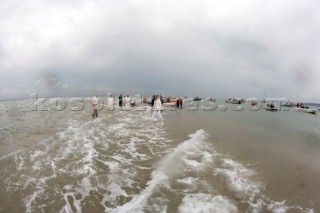 THE SOLENT, UK - August 31st: For a briefÊspellÊonce each summer on the lowest of spring tides, members of the Island Sailing Club and Royal Southern Yacht Club sail outÊto The Brambles sand bank in the middle of The Solent andÊplay cricket, before the tide rushes back in one hour later.ÊThe fixture was first started in the 1950Õs by the late Uffa Fox, a sailing companion of the Duke of Edinburgh, the Royal Southern and the Island Sailing Club compete every year. As soon as the sandbank appears the stumps are put up and the match gets under way. Many of the competitors dress all in cricket whites and ÔThe Bramble InnÕ is erected to serve drinks to spectators. The Bramble Inn is one of the most bizarre pubs in England: it is in the middle of the sea and exists only for about an hour each year.