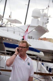 Crew using mobile telephone communication onboard superyacht  - MODEL RELEASED -