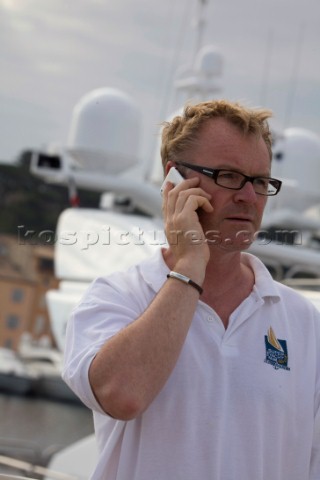 Crew using mobile telephone communication onboard superyacht   MODEL RELEASED 