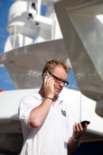 Crew using mobile telephone communication onboard superyacht  - MODEL RELEASED -