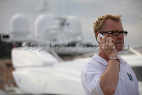 Crew using mobile telephone communication onboard superyacht   MODEL RELEASED 