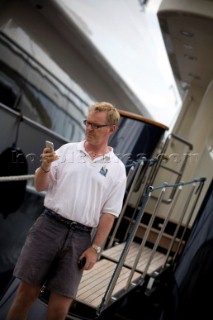 Crew using mobile telephone communication onboard superyacht  - MODEL RELEASED -