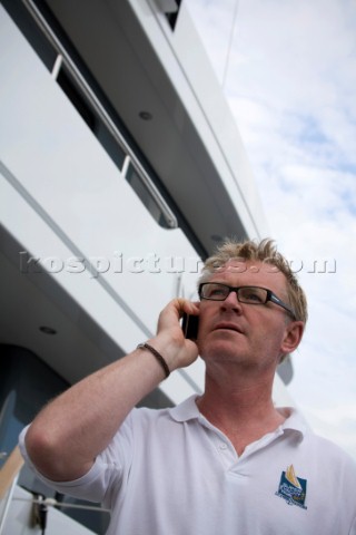 Crew using mobile telephone communication onboard superyacht   MODEL RELEASED 