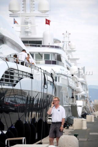 Crew using mobile telephone communication onboard superyacht   MODEL RELEASED 