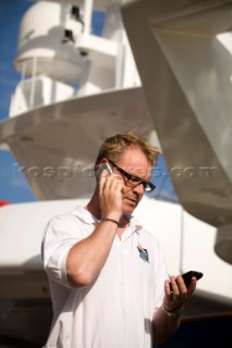 Crew using mobile telephone communication onboard superyacht  - MODEL RELEASED -