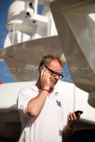 Crew using mobile telephone communication onboard superyacht   MODEL RELEASED 