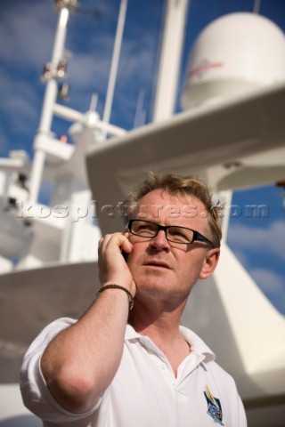 Crew using mobile telephone communication onboard superyacht   MODEL RELEASED 