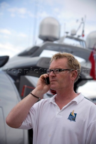 Crew using mobile telephone communication onboard superyacht   MODEL RELEASED 
