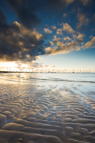 Colourful sunset over a sandy beach at low tide