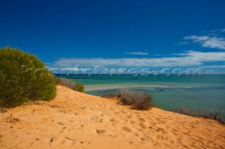 Striking red sand dunes by the sea