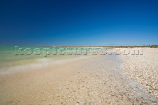 An idyllic beach with crystal blue water and white sand