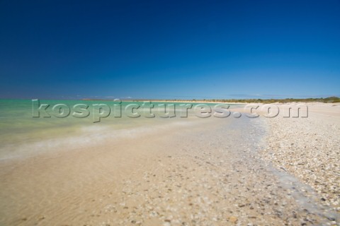 An idyllic beach with crystal blue water and white sand