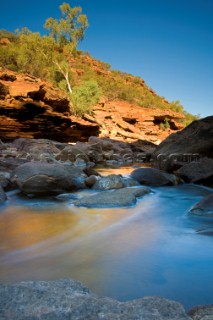 Slow exposure of a colourful stream running over the rocks of an impressive gorge