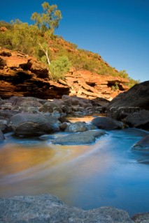 Slow exposure of a colourful stream running over the rocks of an impressive gorge