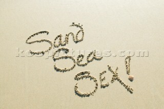 Sand Sea Sex sign writing message on a sandy beach in Tarifa, Spain, near Gibraltar.