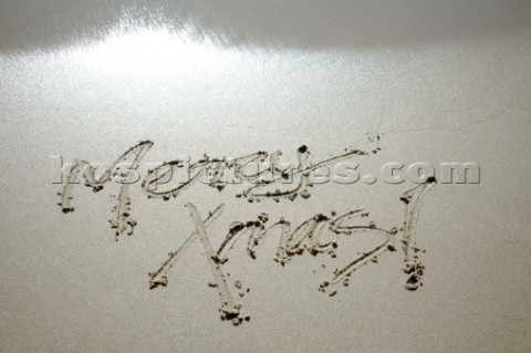 Merry Christmas Xmas sign writing message on a sandy beach in Tarifa Spain near Gibraltar