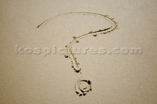 Question mark sign writing message on a sandy beach in Tarifa, Spain, near Gibraltar.