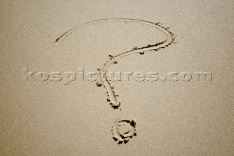 Question mark sign writing message on a sandy beach in Tarifa Spain near Gibraltar