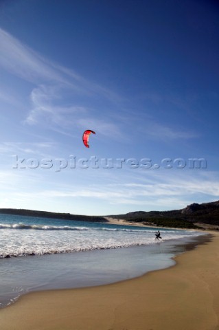 Kite surfer walking on a sandy beach in Tarifa Spain near Gibraltar