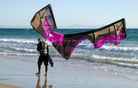 Kite surfer walking on a sandy beach in Tarifa Spain near Gibraltar